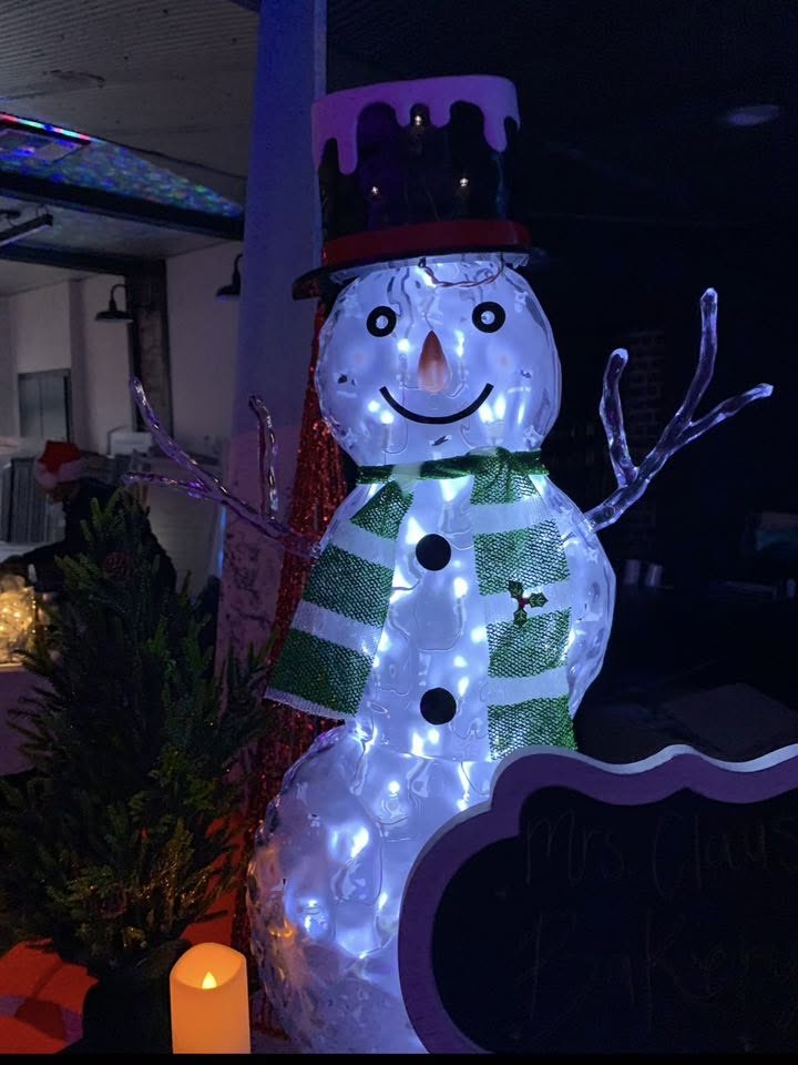 A light-up snowman decoration with a top hat and striped scarf.