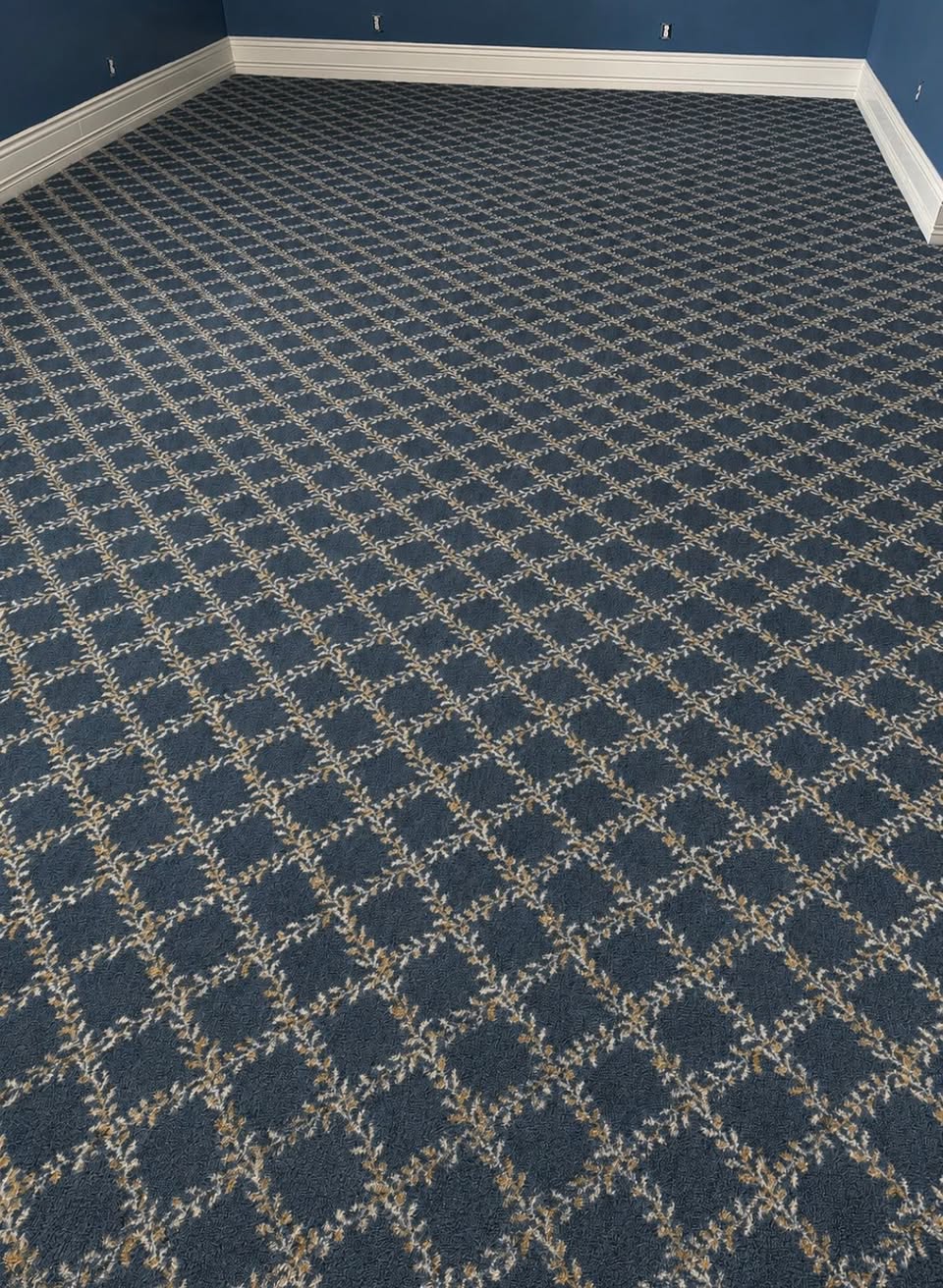 Navy carpet with a cream diamond lattice pattern.