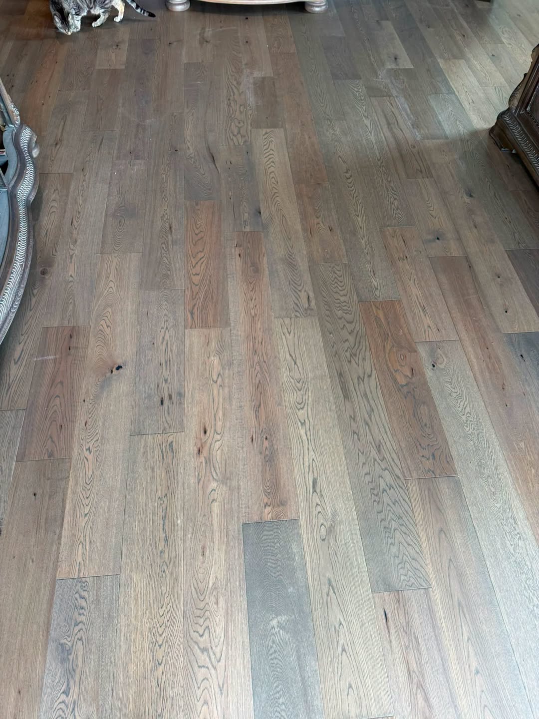 Wide-plank hardwood flooring with rich natural grain variation.