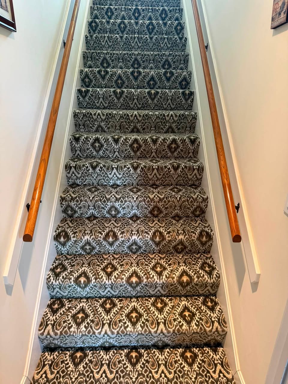 A black-and-white ikat-pattern runner on a long staircase.
