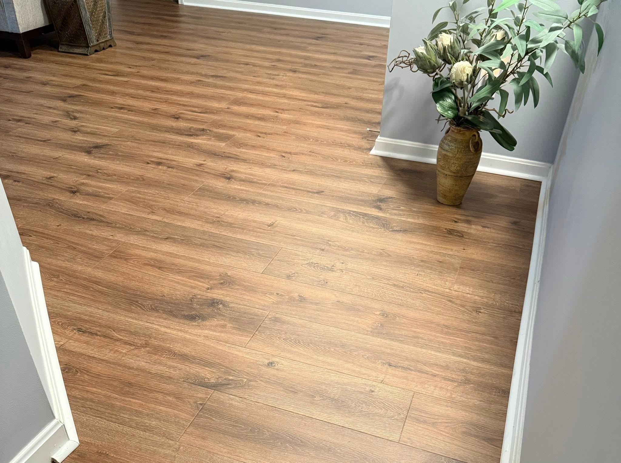 Whitewashed wide-plank hardwood flooring in an entry hallway.