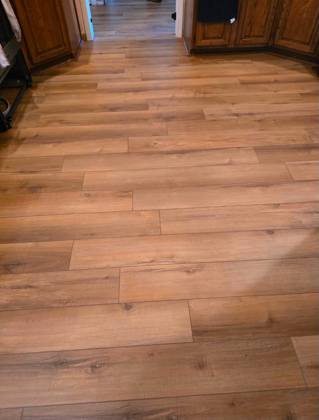 Audacity flooring in the color Cincinnati in a kitchen with oak cabinets.