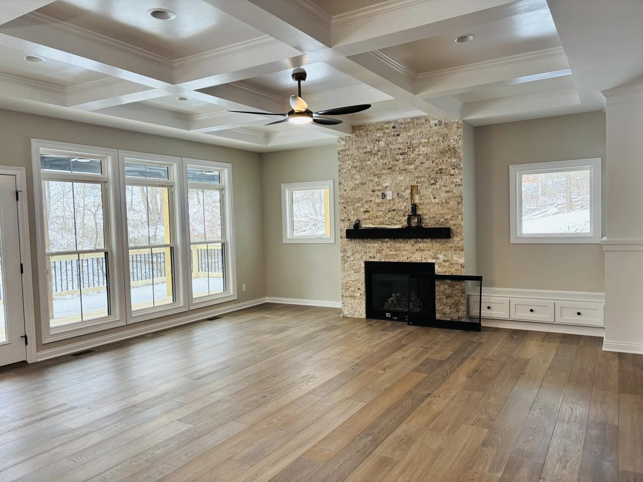 Hallmark Alta Vista hardwood in the color Big Sur, in a new home with a stone fireplace.